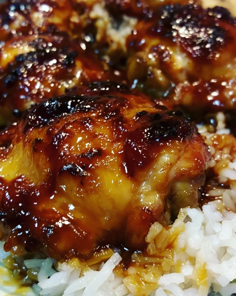 Plate of Honey BBQ Chicken served with rice and garnished with herbs