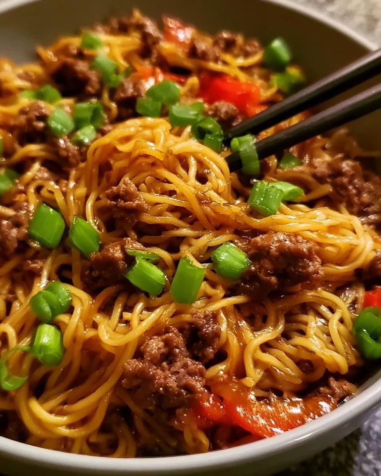 Mongolian Ground Beef Noodles served in a bowl with fresh vegetables and herbs