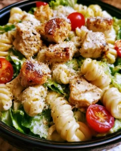 A bowl of Chicken Caesar Pasta Salad with chicken, romaine, and Caesar dressing
